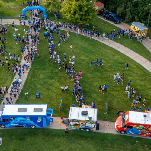 An overhead photo of the Kirkhof Lawn with food trucks and hundreds of people gathered